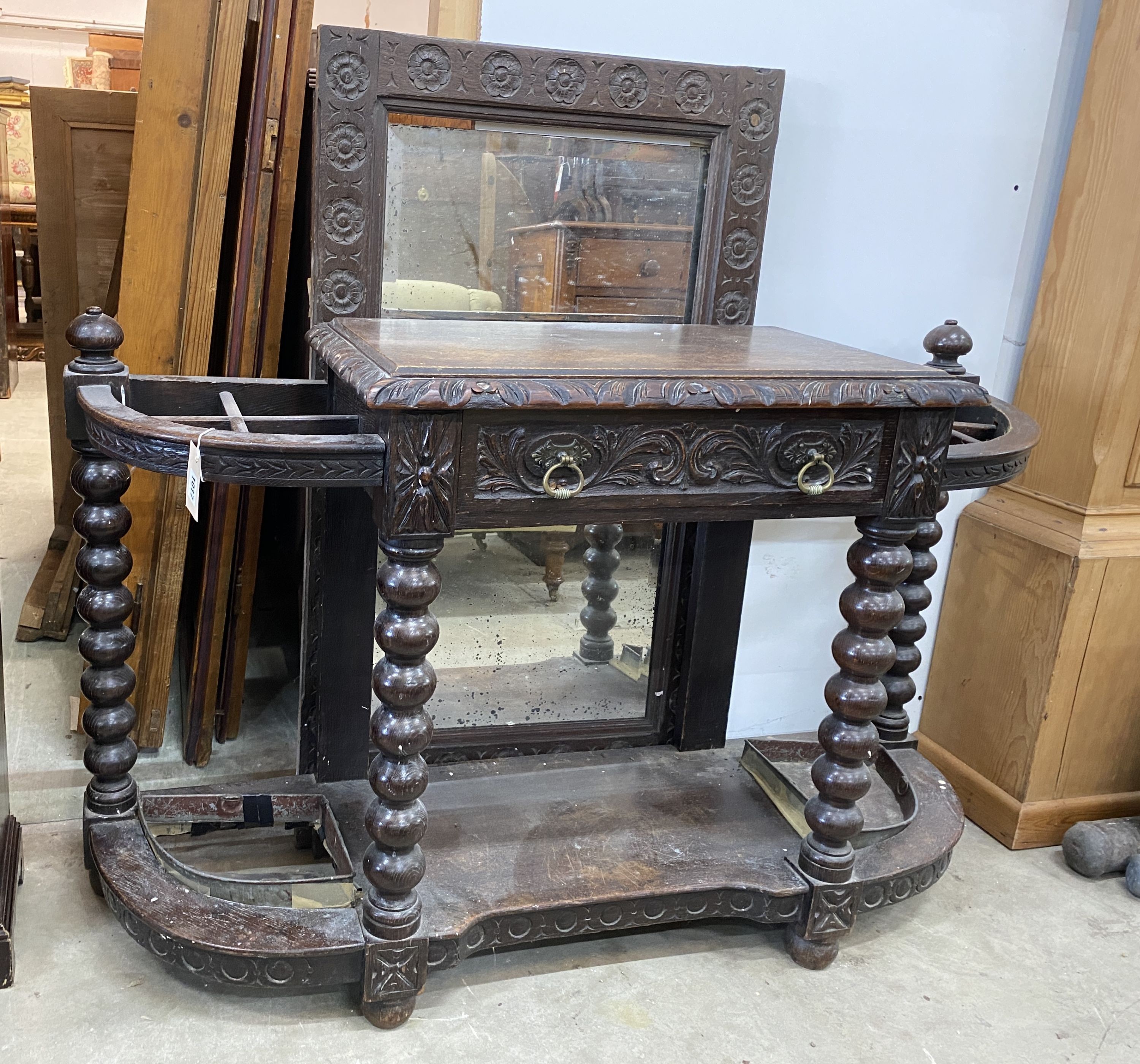 A late Victorian carved oak hall stand with mirror, width 125cm